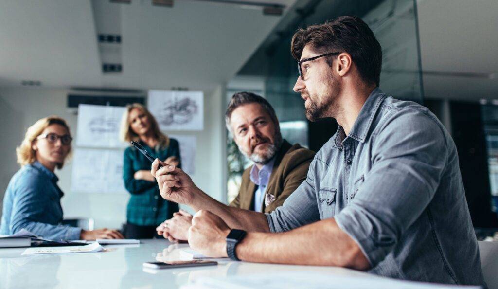 Men in discussion in office